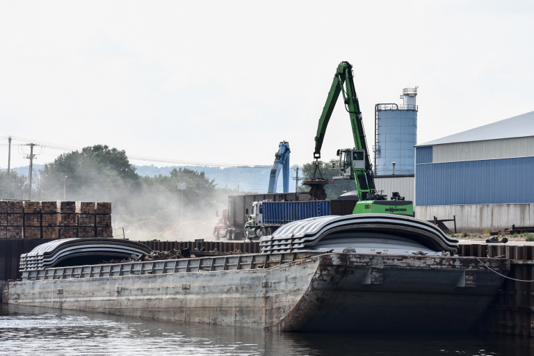 Crane loads scrap metal onto barge